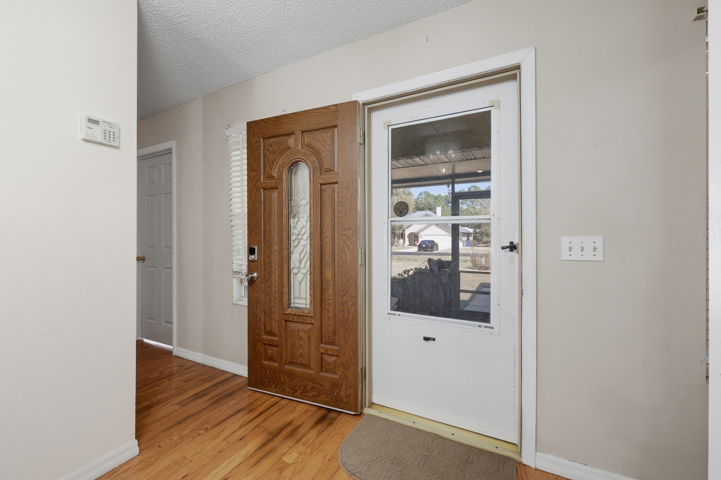 5296 Timucua Circle St. Augustine, FL 32086 - Photo 8 of 65 Entryway featuring a textured ceiling and light wood-style floors