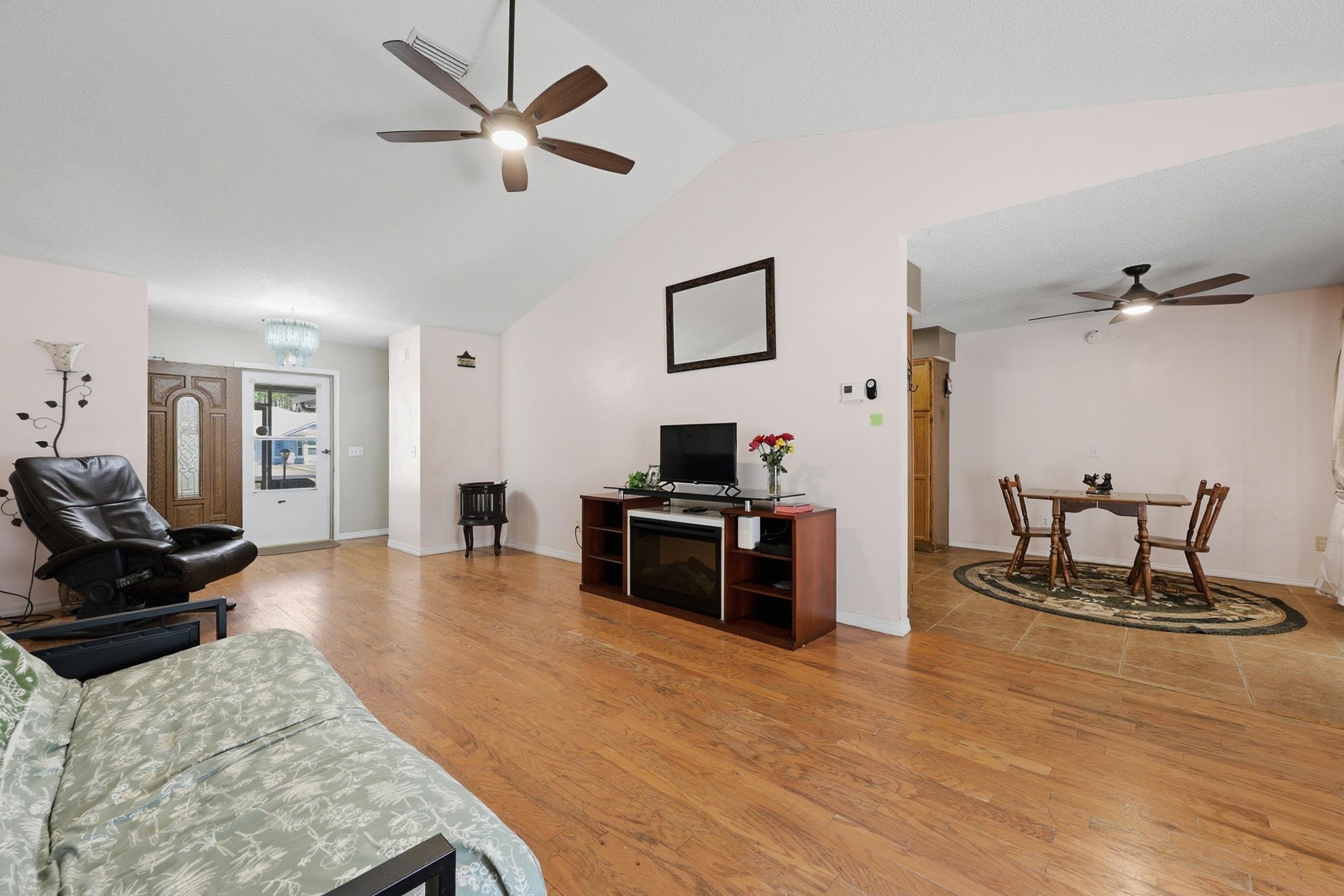 5296 Timucua Circle St. Augustine, FL 32086 - Photo 10 of 65 Living room with a ceiling fan, light wood-type flooring, and a chandelier