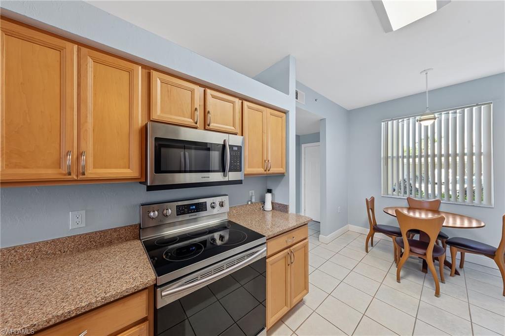 21330 Lancaster Run, Unit 1218 Estero, FL 33928 - Photo 11 of 49 a kitchen with a stove and a microwave