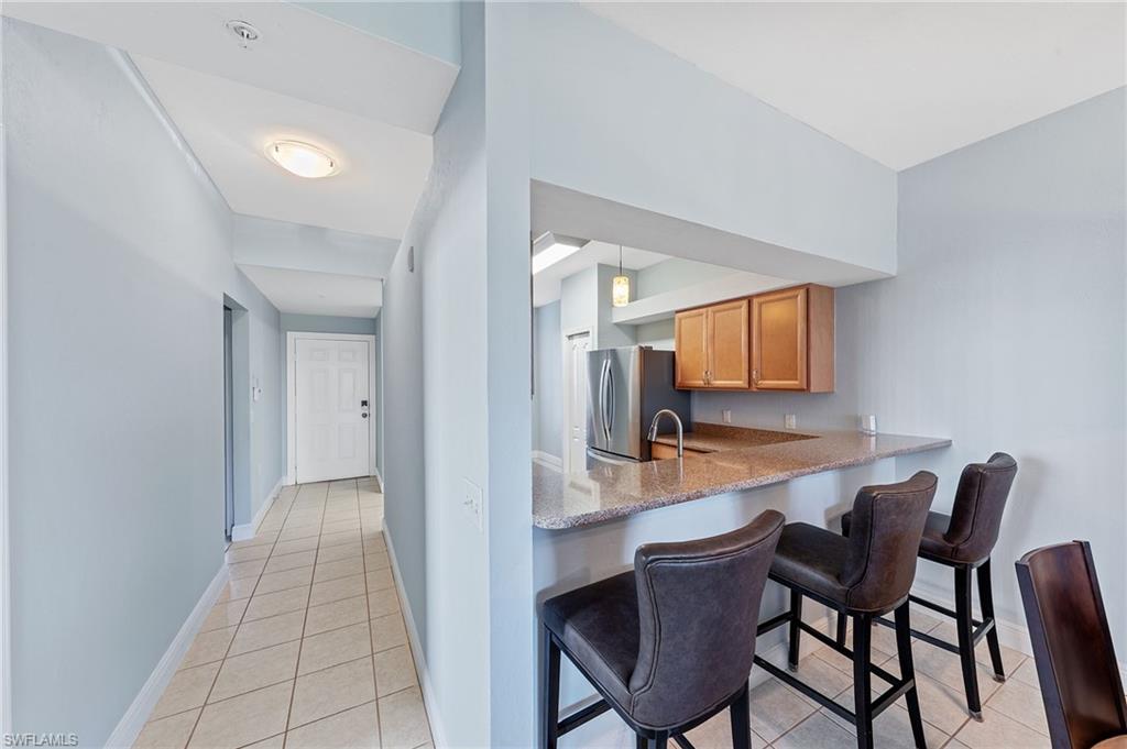 21330 Lancaster Run, Unit 1218 Estero, FL 33928 - Photo 9 of 49 a dining room with furniture and wooden floor