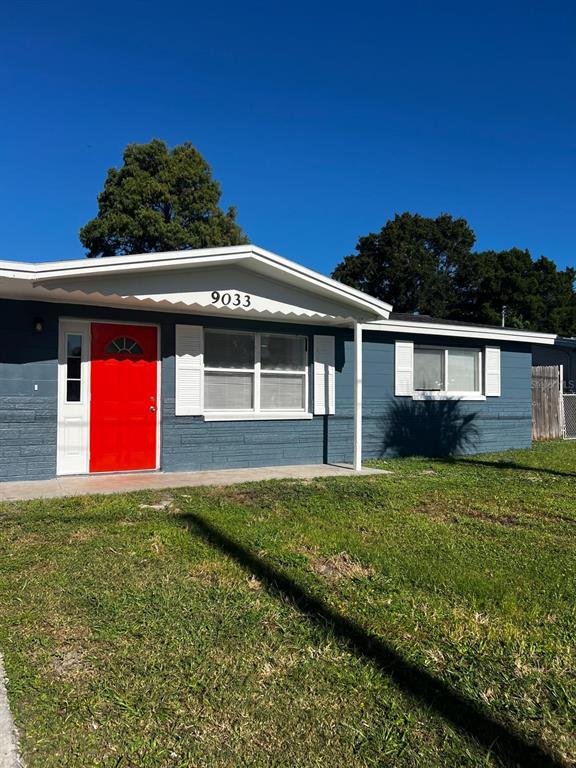 9033 Pegasus Avenue Port Richey, FL 34668 - Photo 13 of 18 a house with garden in front of it
