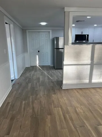 a view of open kitchen with wooden floor and electronic appliances