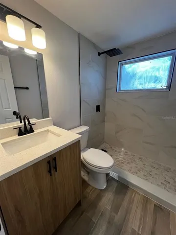 a bathroom with a sink toilet and mirror