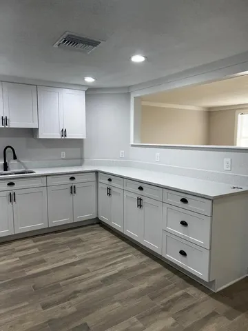 a kitchen with cabinets a sink and dishwasher