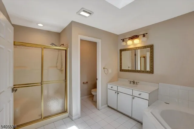 a bathroom with a double vanity sink mirror and shower
