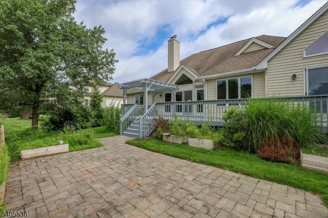 a front view of a house with a yard and potted plants