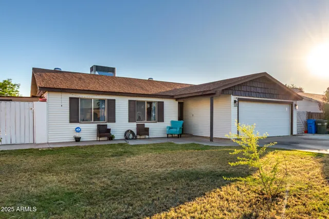 a view of a house with swimming pool and sitting area