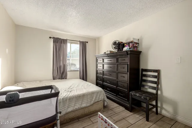 a bedroom with a bed and dresser