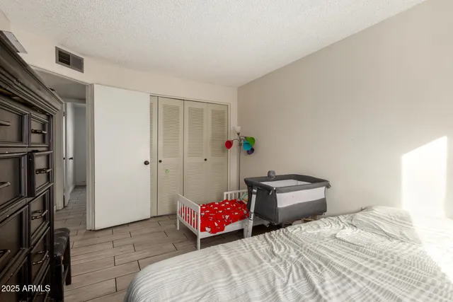 a bedroom with a bed and cabinets