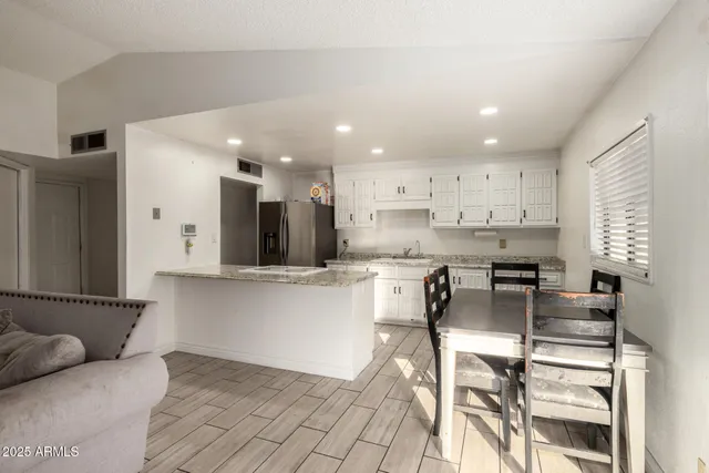 a kitchen with stainless steel appliances kitchen island granite countertop a sink and cabinets