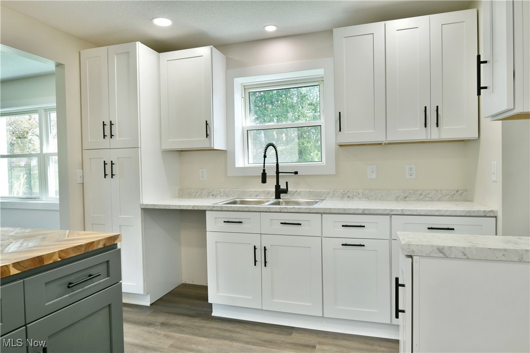 2096 Stillwagon Road Southeast Warren, OH 44484 - Photo 5 of 50 Kitchen featuring a sink, white cabinetry, wooden counters, and light wood-style flooring
