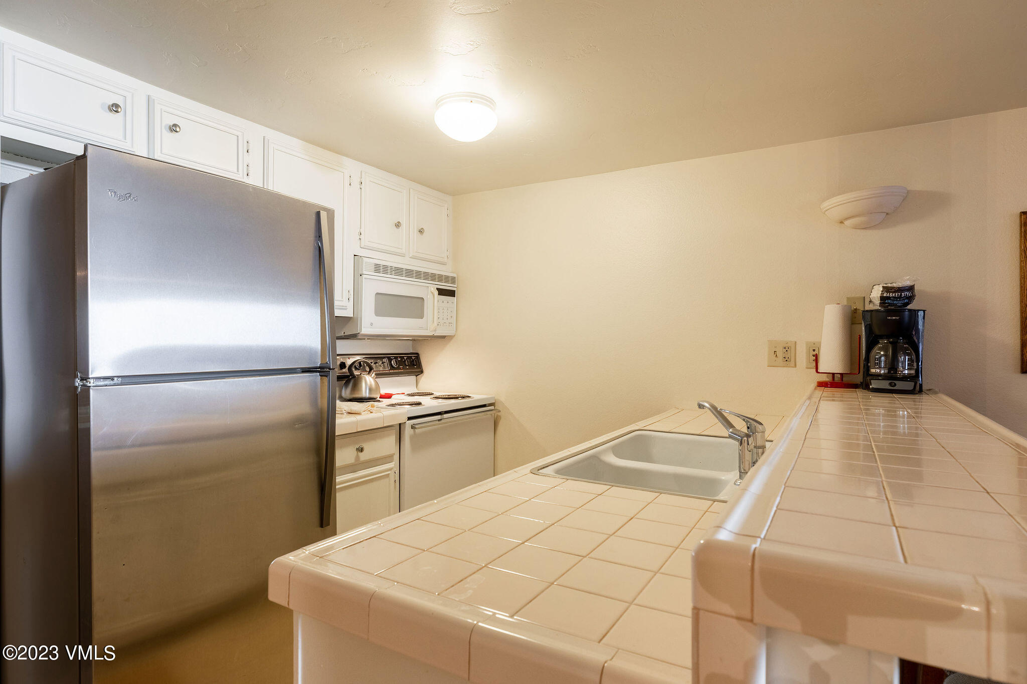 9 Vail Road, Unit 2D Vail, CO 81657 - Photo 4 of 11 a kitchen with a refrigerator and a stove