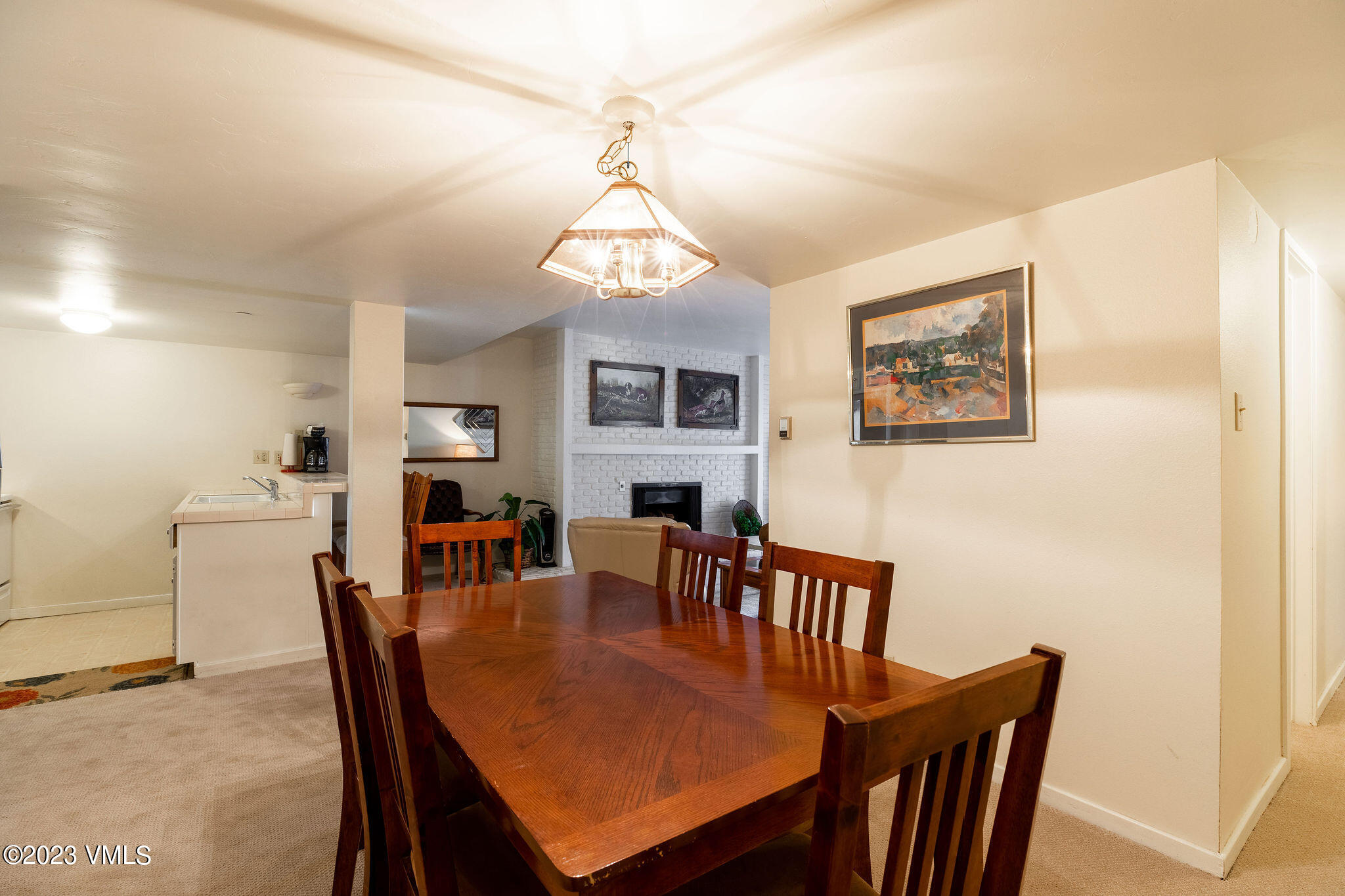 9 Vail Road, Unit 2D Vail, CO 81657 - Photo 5 of 11 a view of a dining room with furniture a chandelier and wooden floor