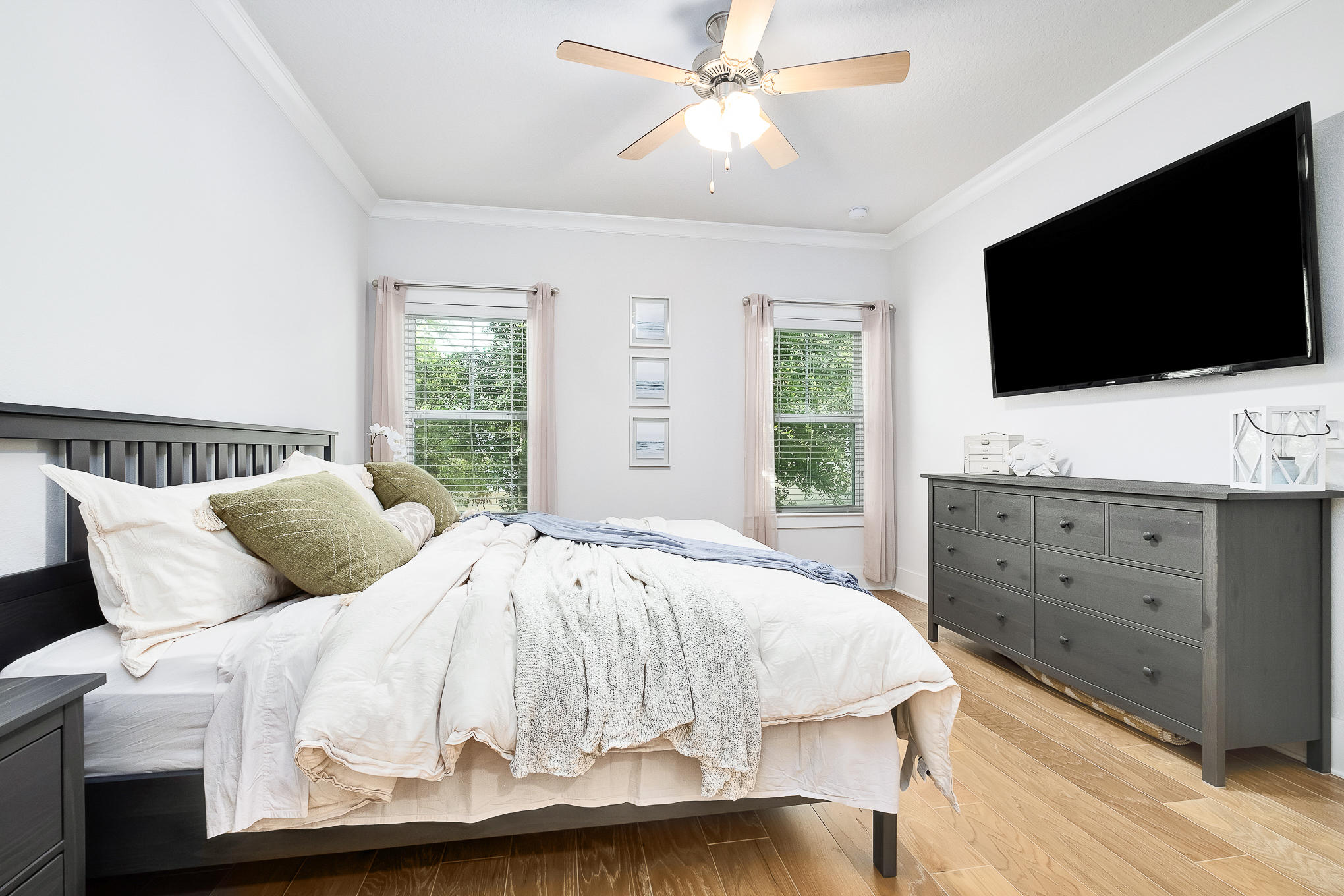 386 Grande Pointe Circle Inlet Beach, FL 32461 - Photo 16 of 50 a bedroom with a large bed and a flat tv screen on dresser