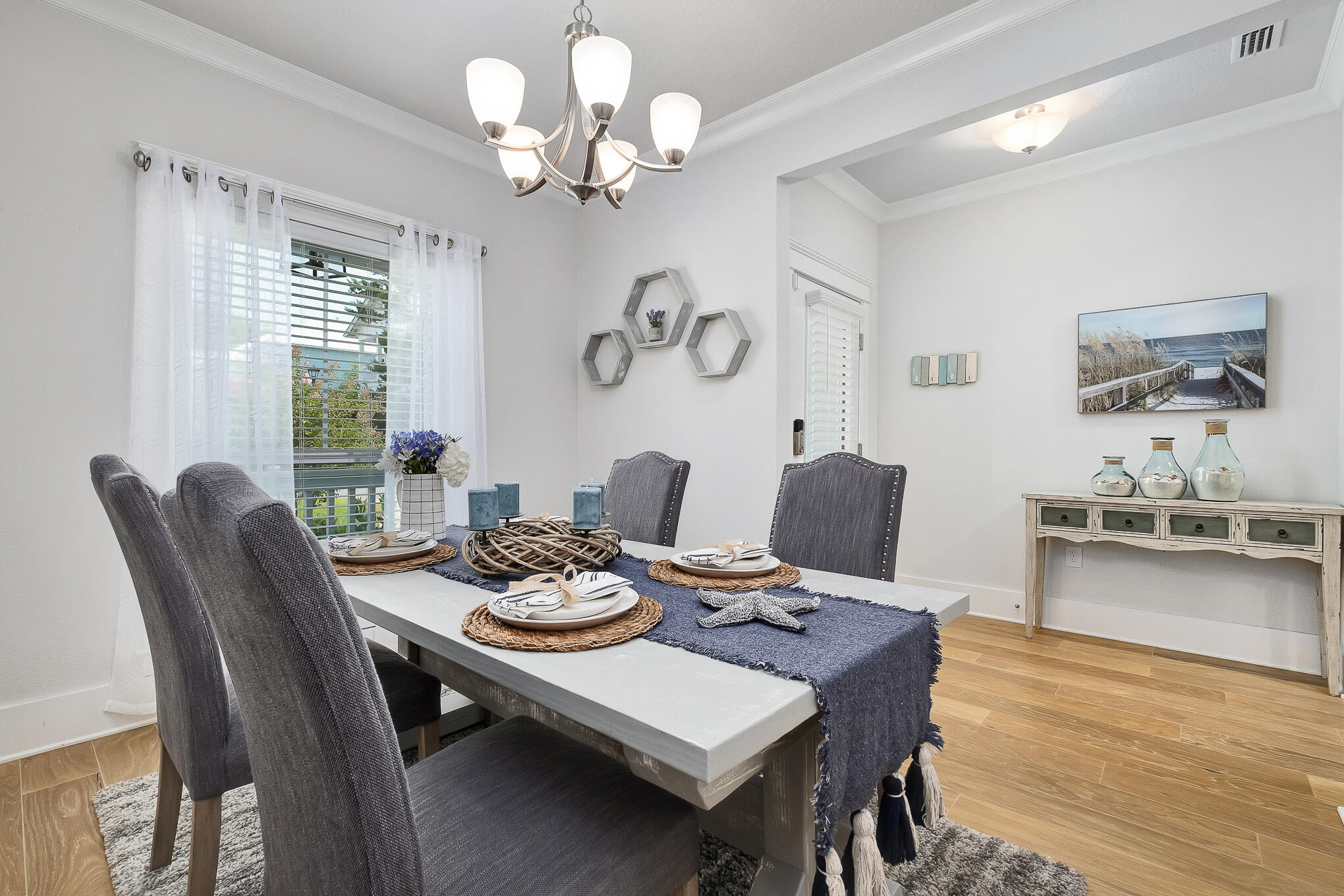 386 Grande Pointe Circle Inlet Beach, FL 32461 - Photo 2 of 50 a view of a dining room with furniture a chandelier and wooden floor