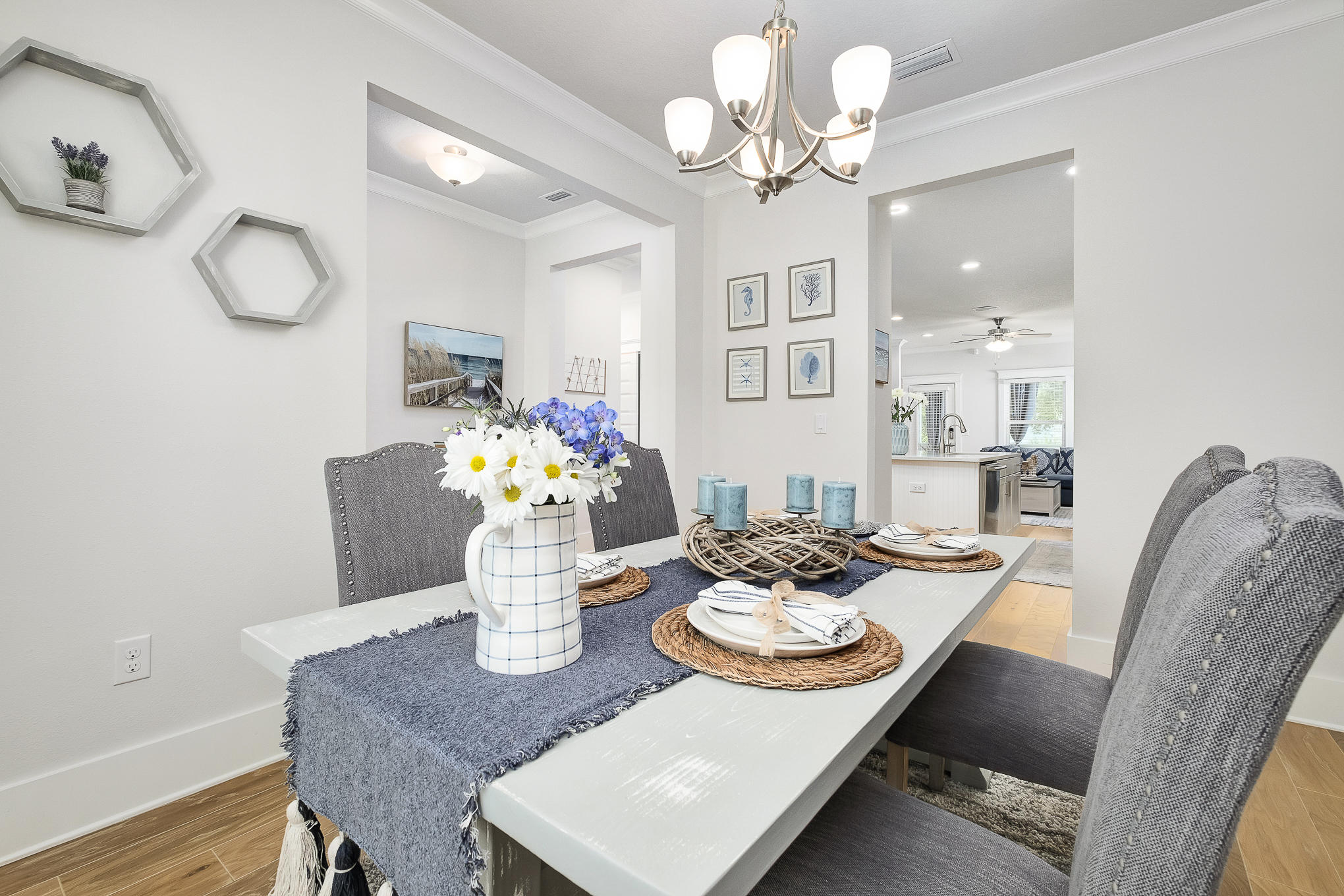 386 Grande Pointe Circle Inlet Beach, FL 32461 - Photo 4 of 50 a view of a dining room with furniture a chandelier and wooden floor