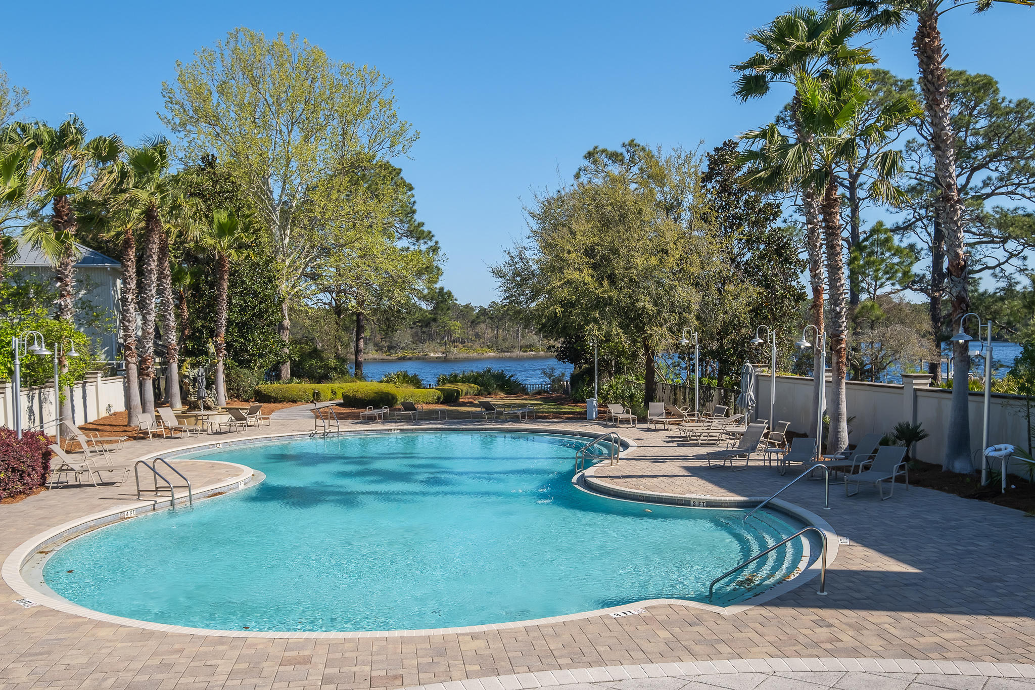 386 Grande Pointe Circle Inlet Beach, FL 32461 - Photo 46 of 50 a view of a swimming pool with chairs