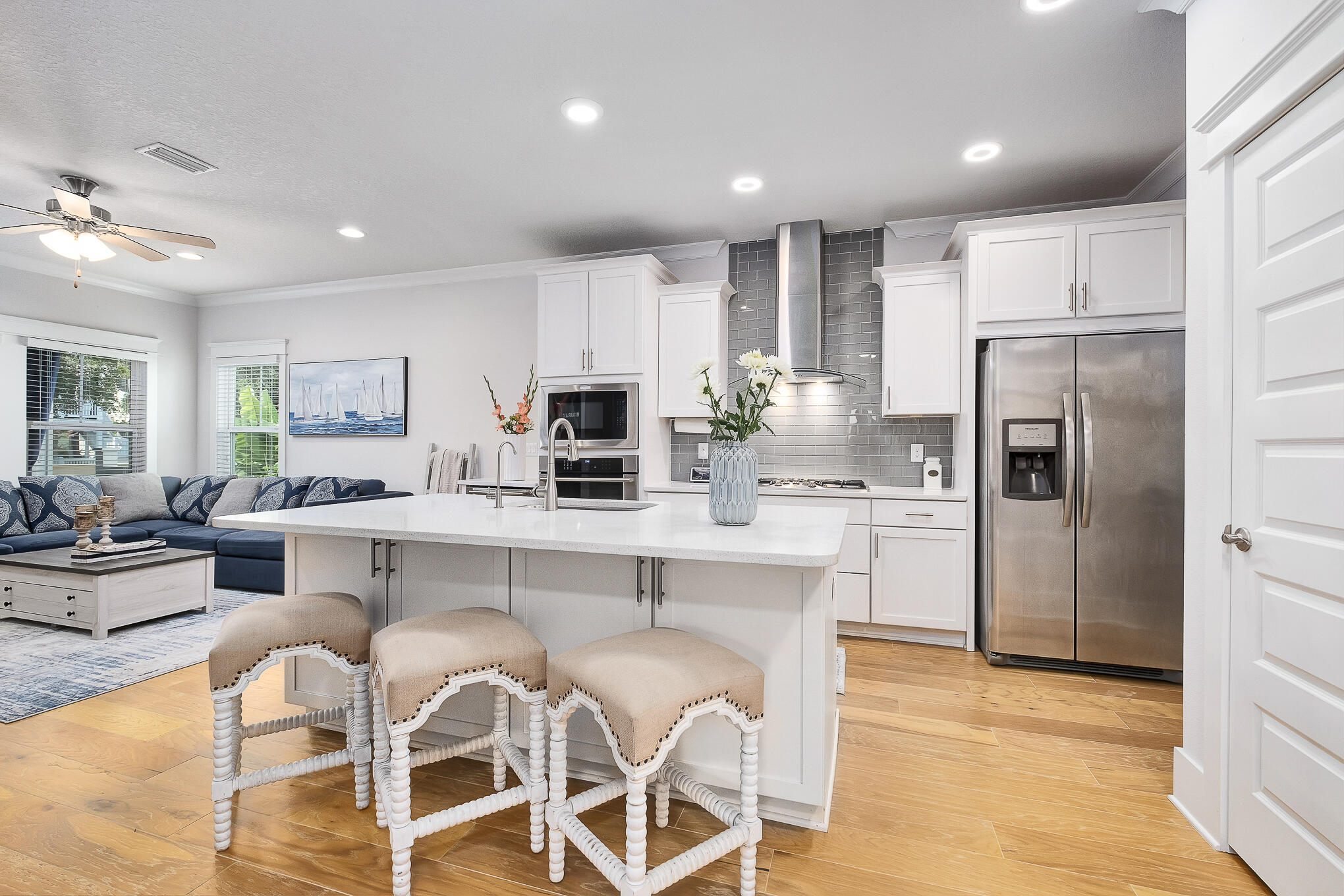 386 Grande Pointe Circle Inlet Beach, FL 32461 - Photo 7 of 50 a kitchen with white cabinets and stainless steel appliances