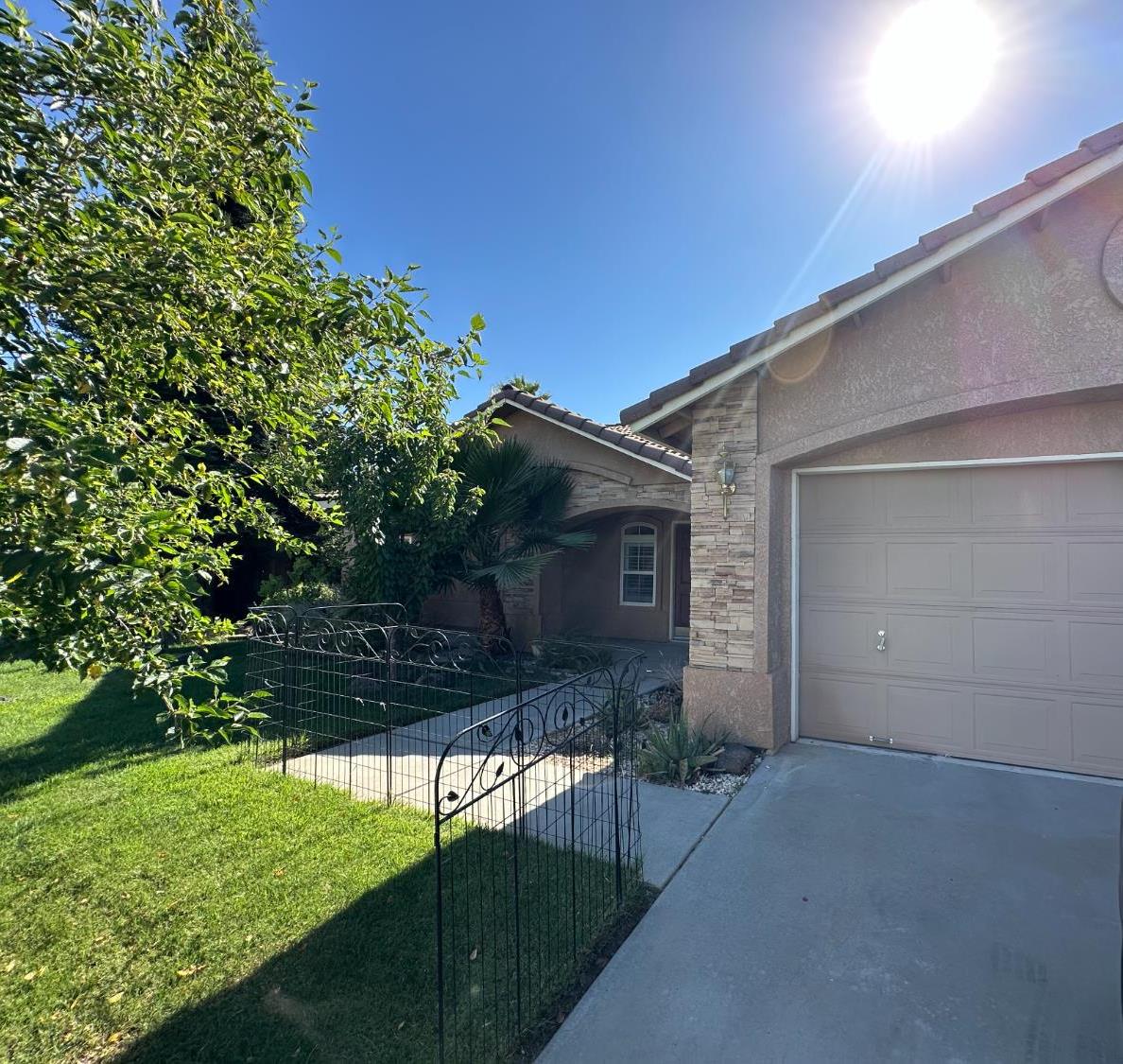 220 South Double Tree Way Madera, CA 93637 - Photo 3 of 69 a front view of a house with a yard