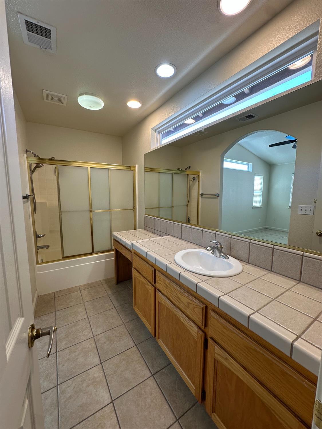 220 South Double Tree Way Madera, CA 93637 - Photo 54 of 69 a bathroom with a sink a toilet and mirror