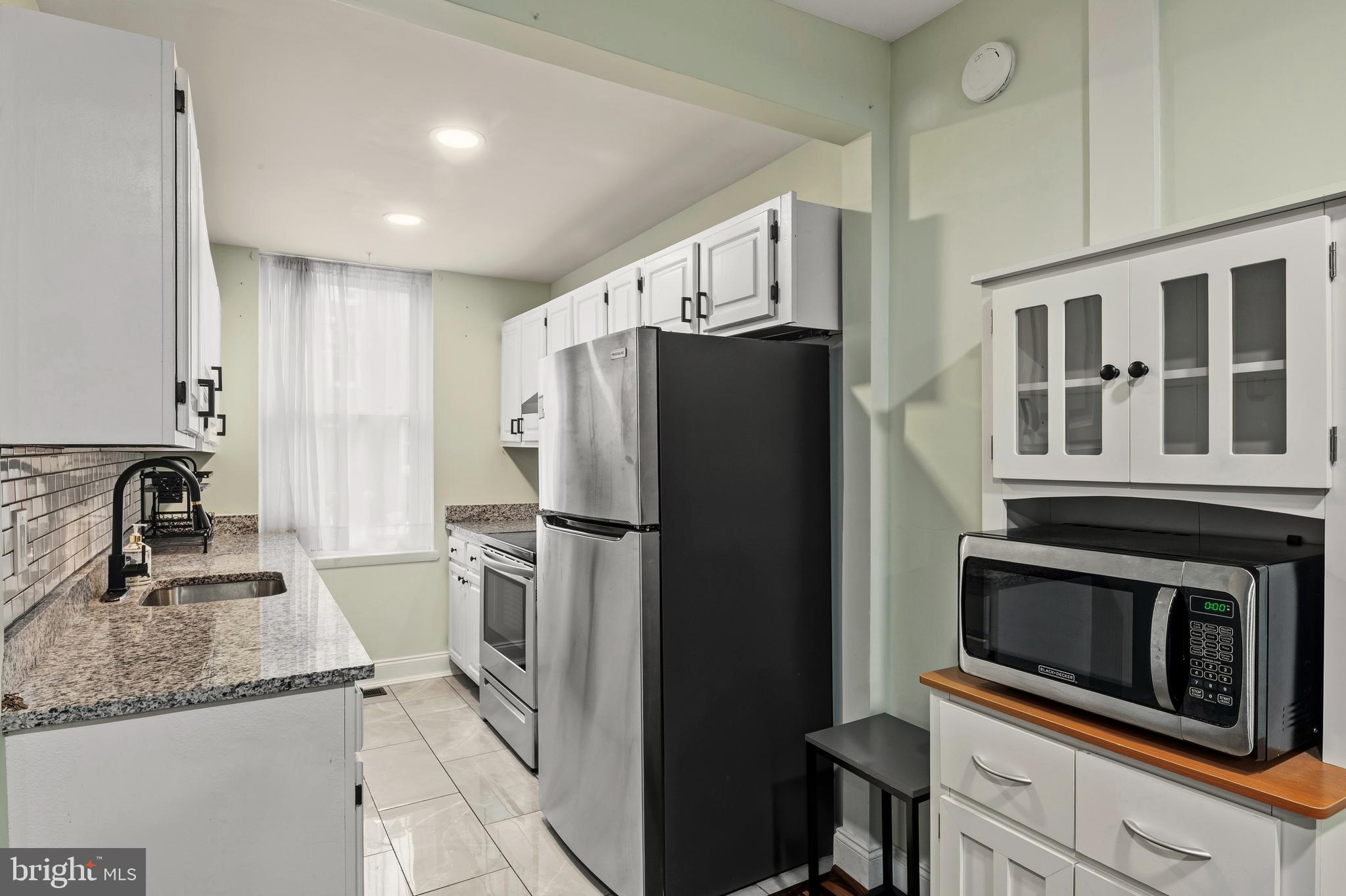 636 Portland Street Baltimore, MD 21230 - Photo 7 of 20 a kitchen with a refrigerator sink and microwave
