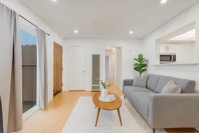 a living room with furniture and a potted plant