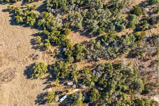 a view of a yard with wooden fence