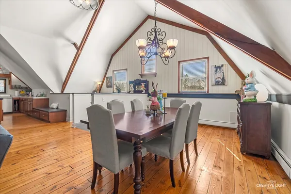 a view of a dining room with furniture and chandelier