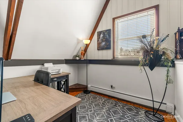 a hallway with a table and a potted plant