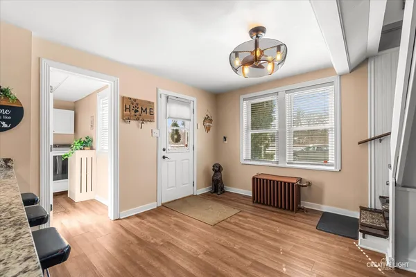 a kitchen with granite countertop a refrigerator stove and microwave