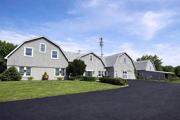a front view of house with yard and green space