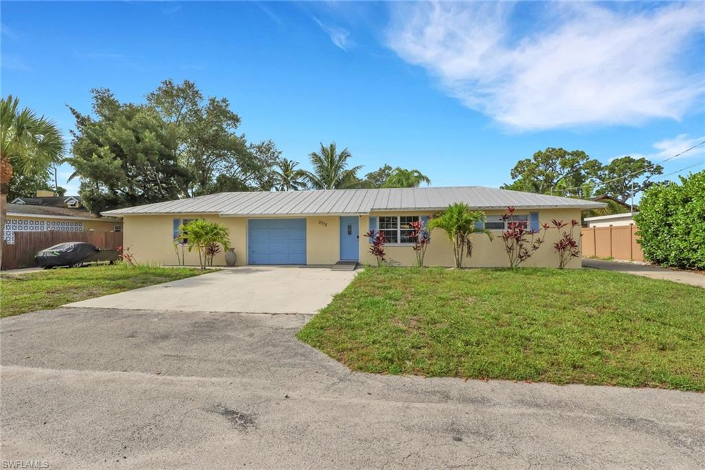 2772 Riverview Drive Naples, FL 34112 - Photo 1 of 23 front view of a house with a yard
