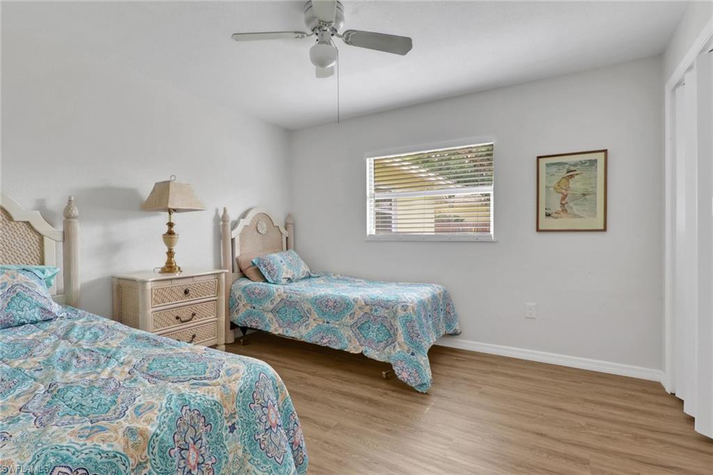 2772 Riverview Drive Naples, FL 34112 - Photo 11 of 23 a bedroom with a bed and wooden floor