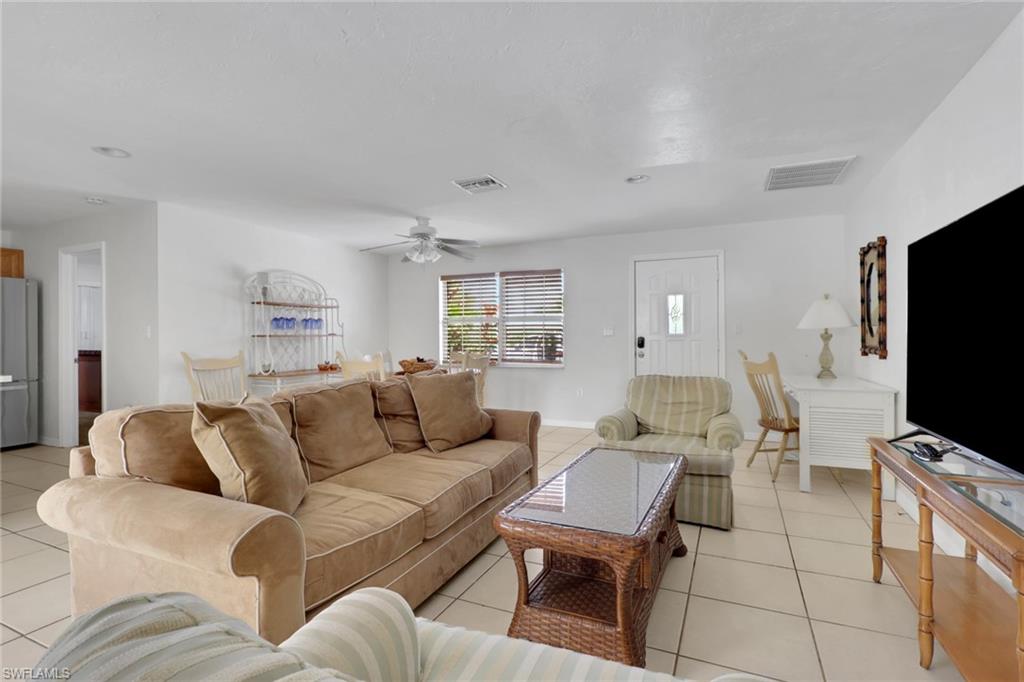 2772 Riverview Drive Naples, FL 34112 - Photo 15 of 23 a living room with furniture and a flat screen tv