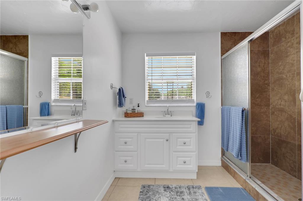 2772 Riverview Drive Naples, FL 34112 - Photo 18 of 23 a kitchen with a sink a window and cabinets