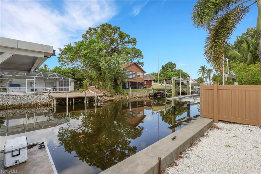 2772 Riverview Drive Naples, FL 34112 - Photo 21 of 23 a view of a swimming pool with a patio