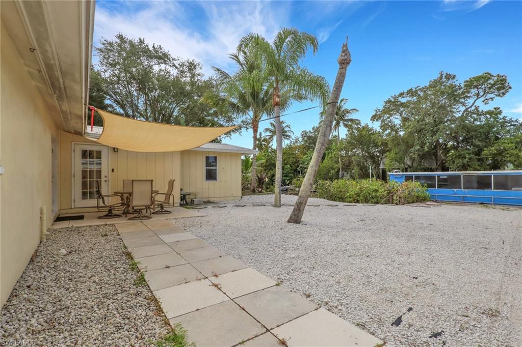 2772 Riverview Drive Naples, FL 34112 - Photo 3 of 23 a view of a house with a backyard and a tree