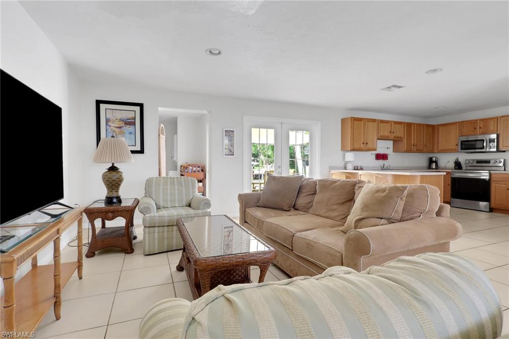 2772 Riverview Drive Naples, FL 34112 - Photo 4 of 23 a living room with furniture and a flat screen tv