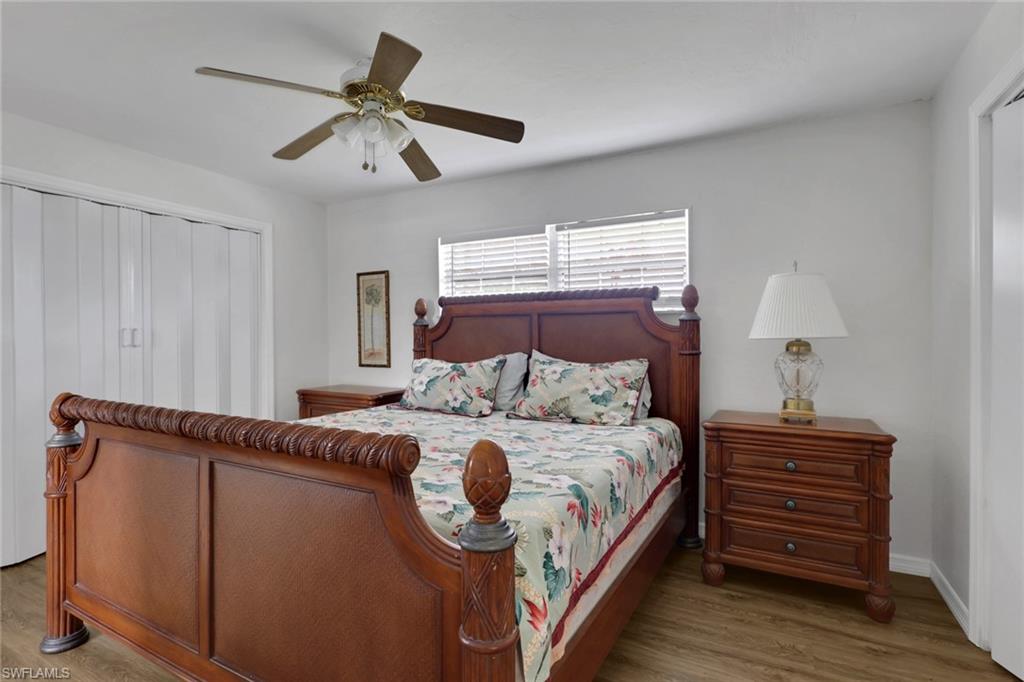 2772 Riverview Drive Naples, FL 34112 - Photo 5 of 23 a bedroom with a bed and a chandelier