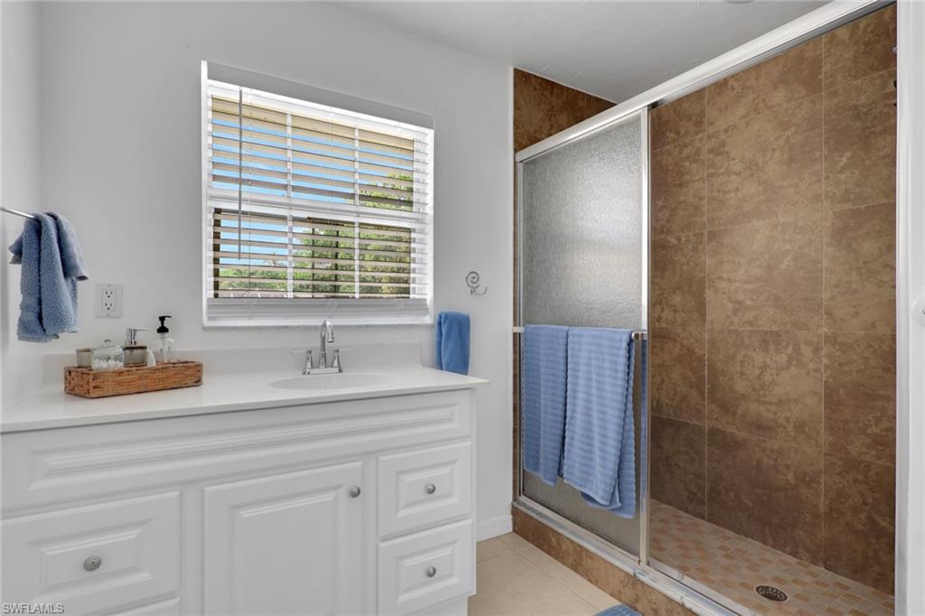2772 Riverview Drive Naples, FL 34112 - Photo 6 of 23 a bathroom with a sink and a mirror