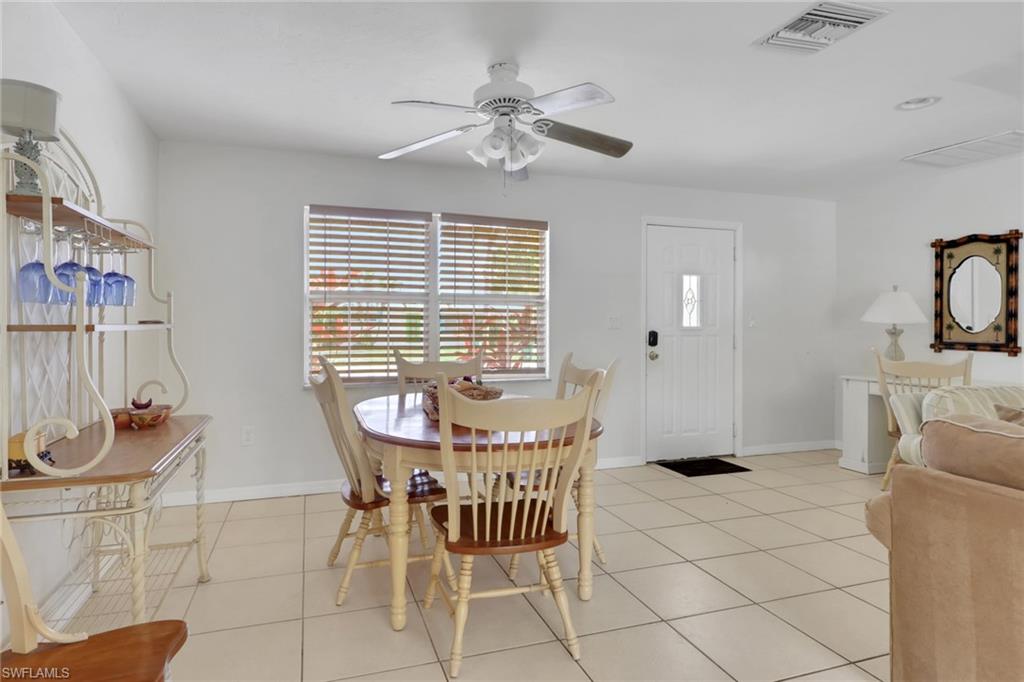 2772 Riverview Drive Naples, FL 34112 - Photo 7 of 23 a view of a dining room with furniture and chandelier