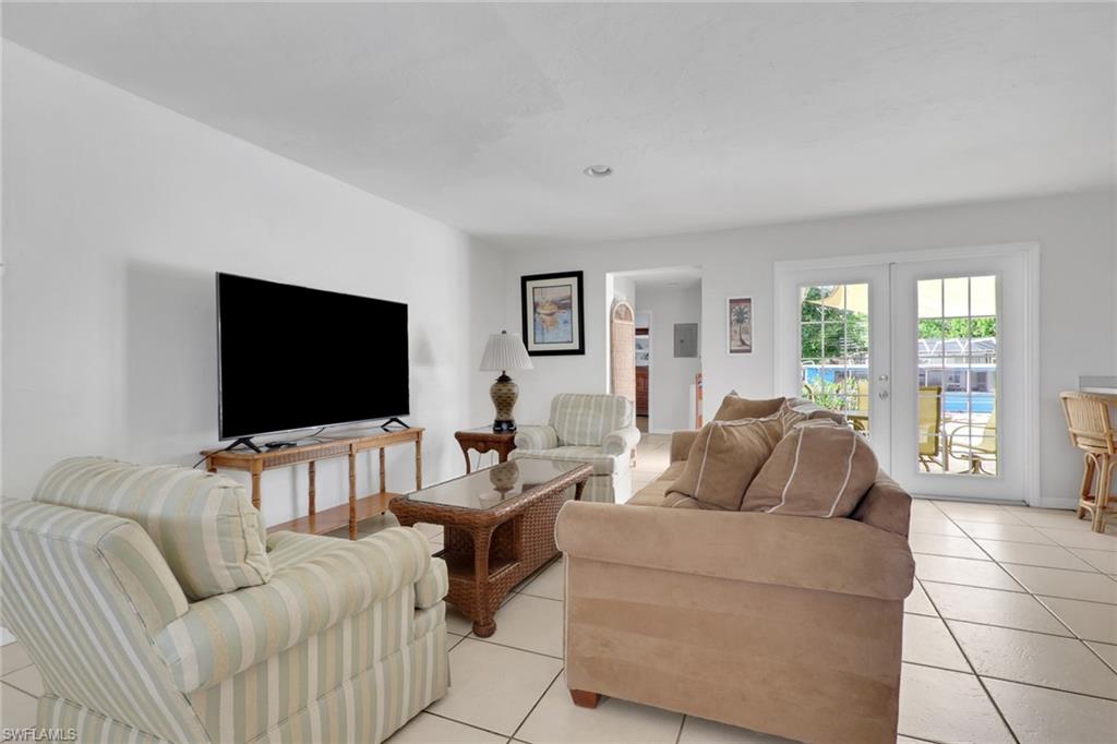 2772 Riverview Drive Naples, FL 34112 - Photo 10 of 23 a living room with furniture and a flat screen tv