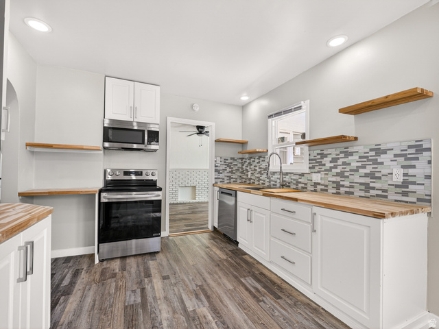 74 South 300 East Springville, UT 84663 - Photo 8 of 48 Kitchen with wood-finish flooring, white cabinetry, and wood countertops