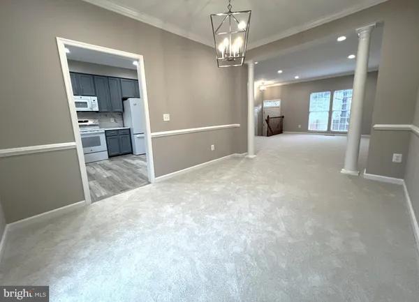 a kitchen with a white refrigerator a sink a stove a microwave and cabinets