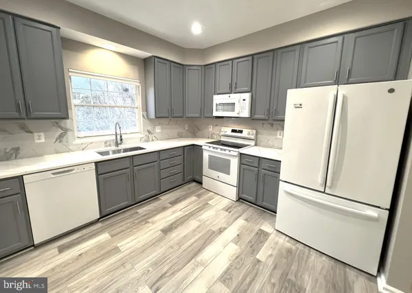 a view of a hallway with wooden floor and closet