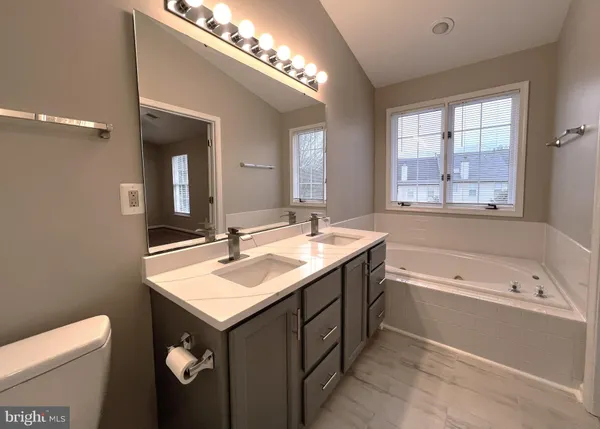 a bathroom with a sink a mirror and vanity