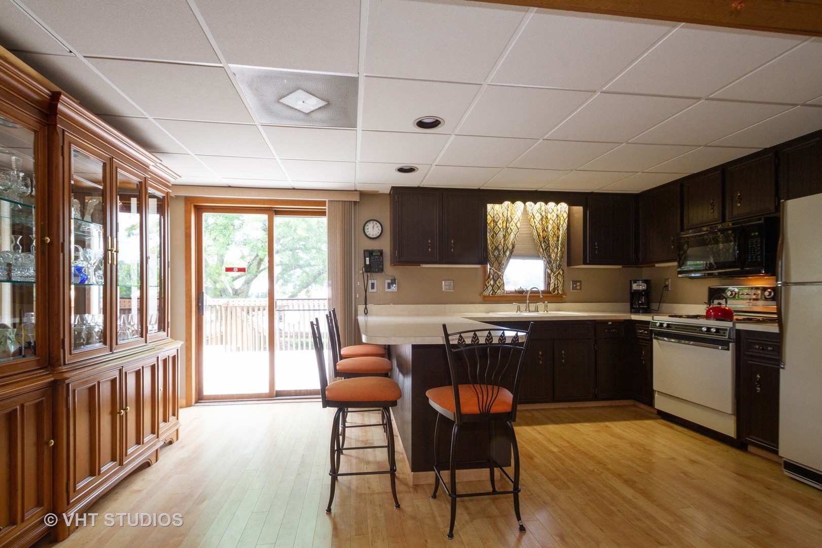 514 Windsor Road Loves Park, IL 61111 - Photo 7 of 33 a kitchen with stainless steel appliances granite countertop a stove a refrigerator a sink dishwasher a dining table and chairs with wooden floor