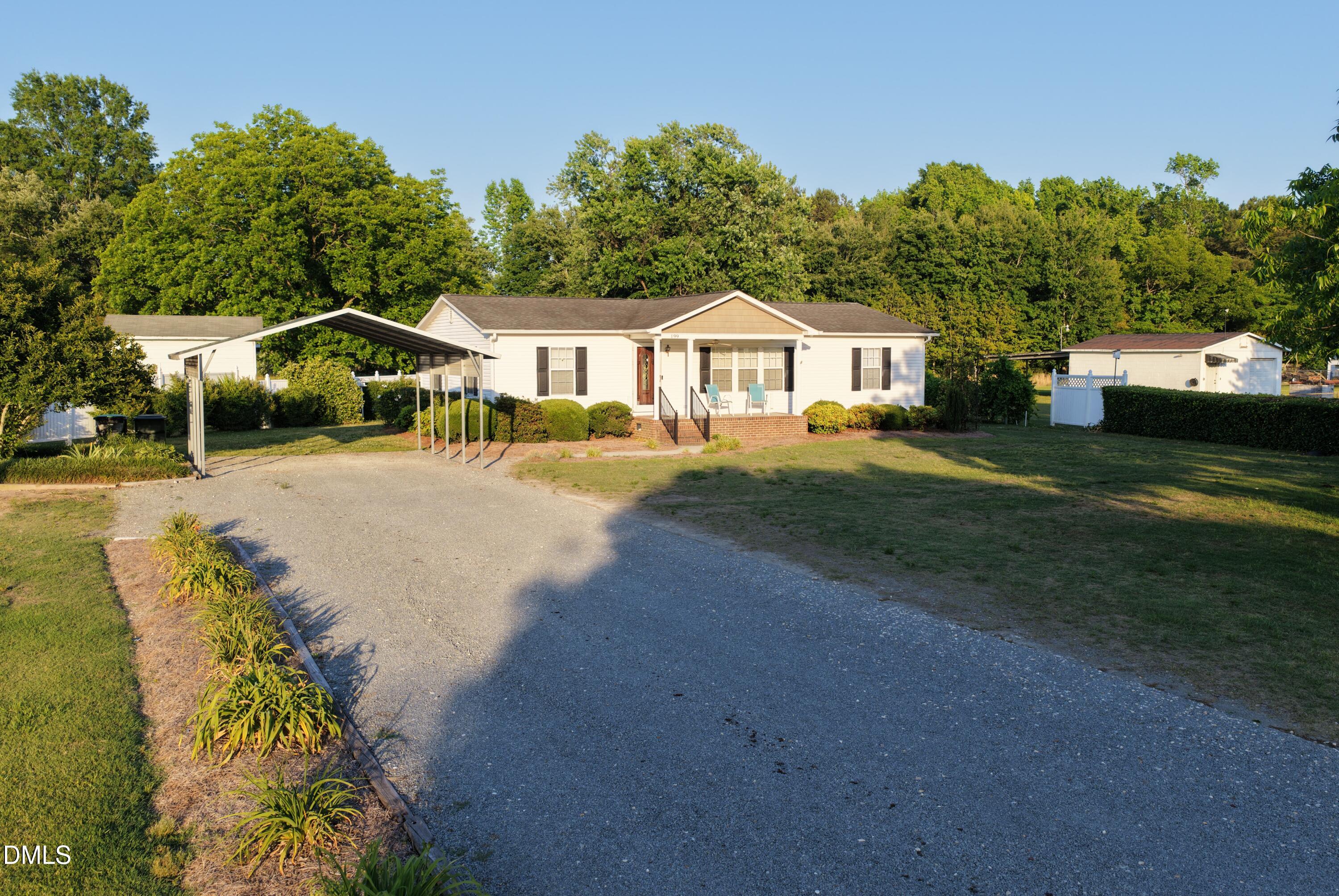 199 Iris Bryant Road Erwin, NC 28339 - Photo 3 of 33 a front view of a house with a garden