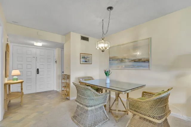 a view of a dining room with furniture and a chandelier