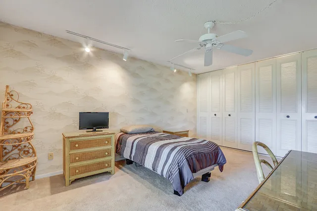 a bedroom with a bed and ceiling fan
